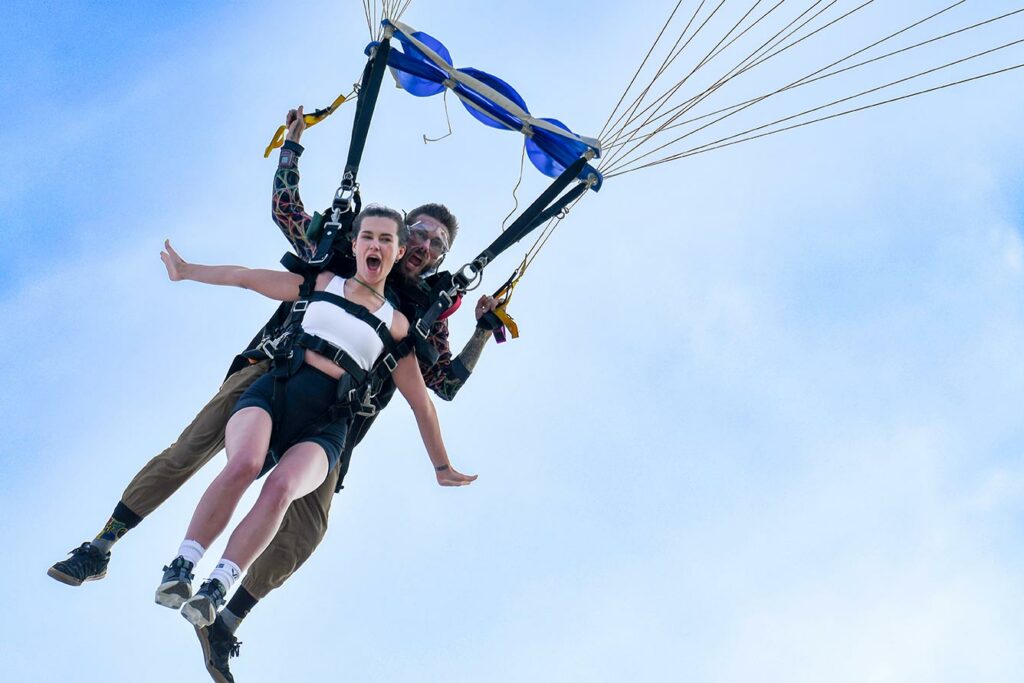 Tandem skydivers coming in for landing